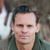 Testimonials man wearing green jacket avatar - Testimonials